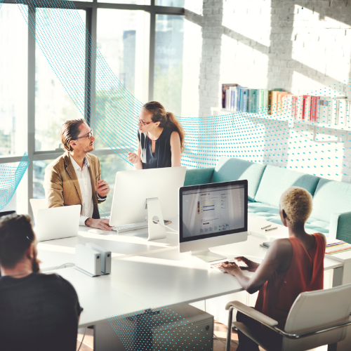Group of office workers in a co-working space analyzing data