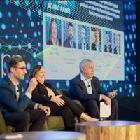 Tom Secaur moderating the panel on the InvestOps stage 