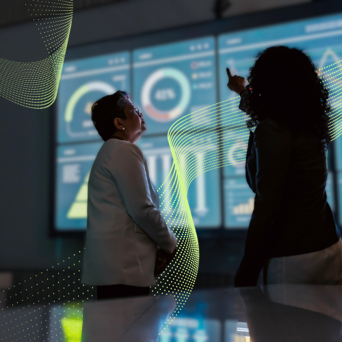 Two women analyzing data on a screen