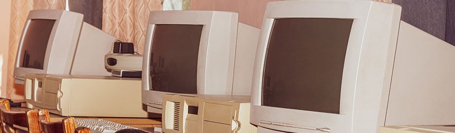 Row of old computers on desk