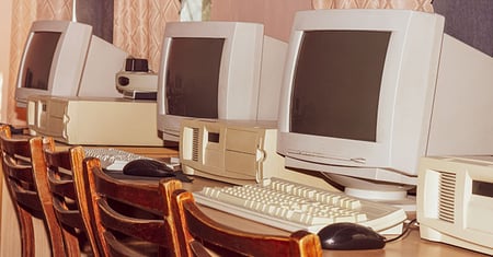 Row of retro computers on a desk