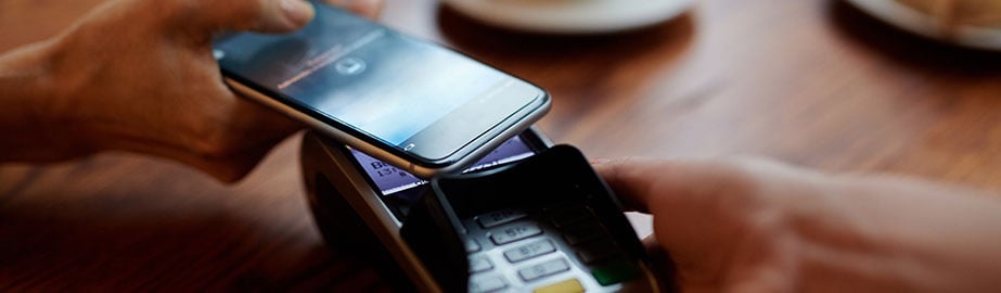 Customer using mobile payment at cafe