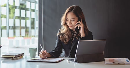 Woman working while on phone
