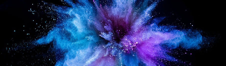 Colorful explosion with turquoise, blue, and purple smoke and sparks