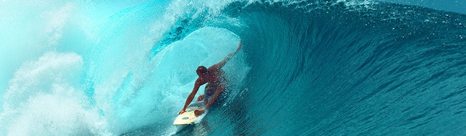 Close up of surfer riding wave