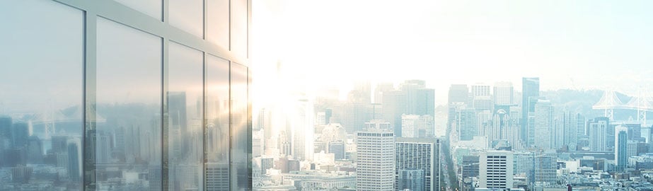 City skyline and modern building with reflected bright sunlight